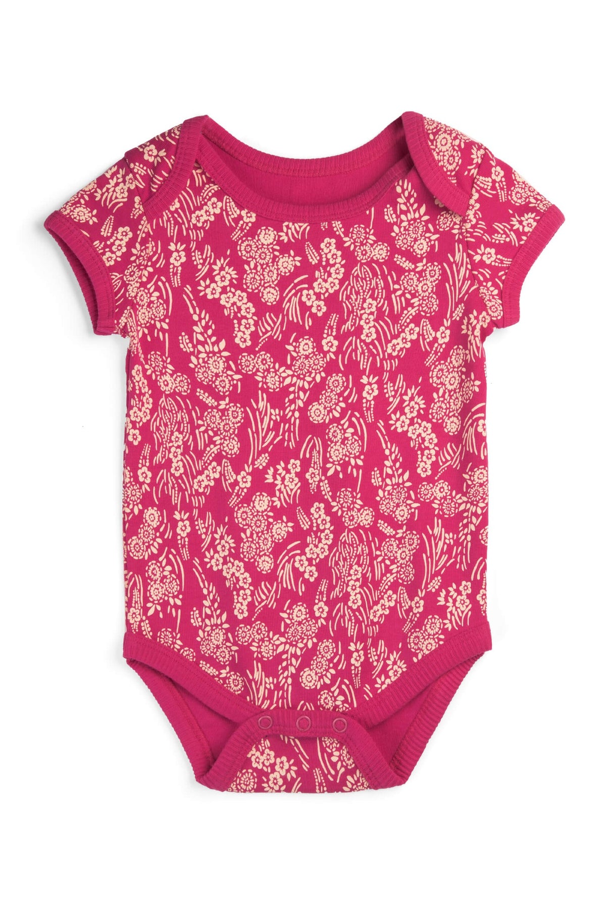 A short-sleeve baby bodysuit in vibrant magenta pink, featuring an all-over cream floral and botanical pattern, laid flat against a white background. 