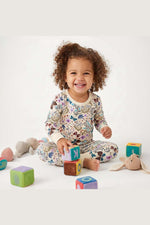 Child playing with colorful blocks on a white background