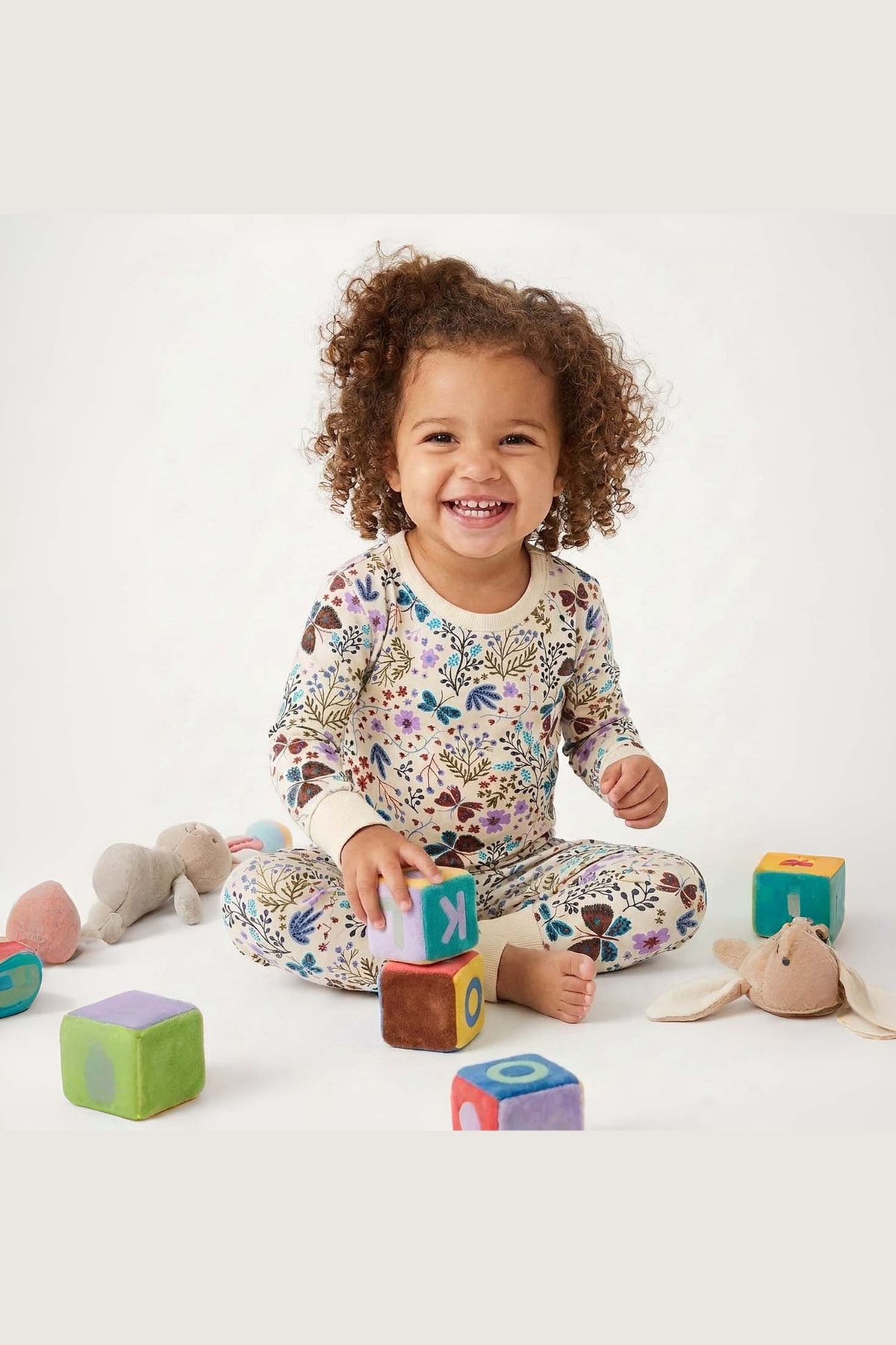 Child playing with colorful blocks on a white background