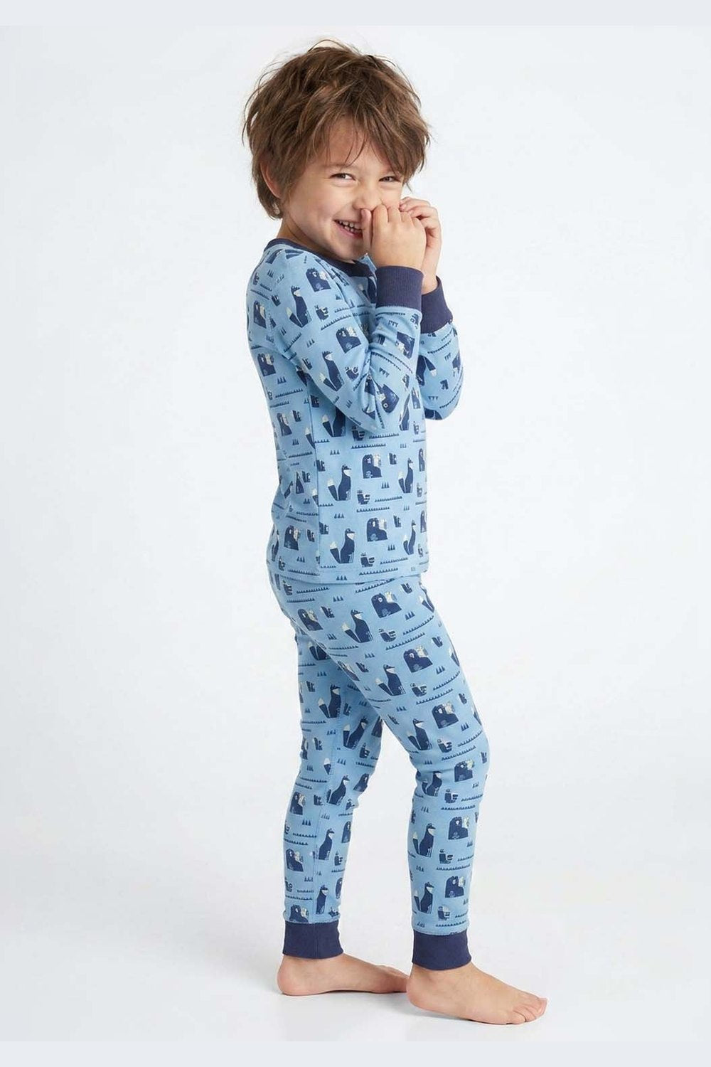 Child wearing blue pajamas with a pattern on a white background 
#bear-venture