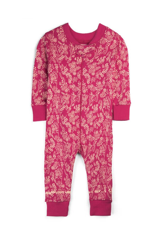 A baby long-sleeve footless jumpsuit in a vibrant magenta pink color, featuring an all-over beige floral and botanical pattern. The garment has solid magenta cuffs and a matching crew neck, photographed flat against a clean white background. 