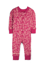 A baby long-sleeve footless jumpsuit in a vibrant magenta pink color, featuring an all-over beige floral and botanical pattern. The garment has solid magenta cuffs and a matching crew neck, photographed flat against a clean white background. 