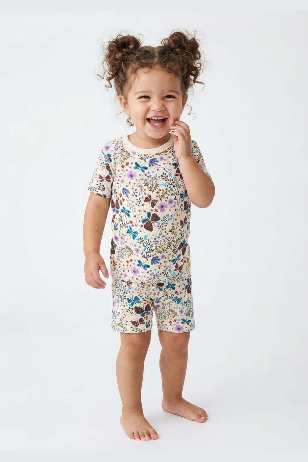 Child wearing floral pajamas on a white background 