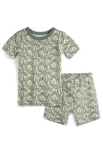 Children's pajama set with short-sleeve top and shorts featuring a green pattern on a beige background.