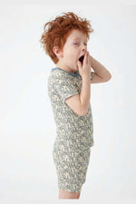 Child wearing a snake print pajamas on a white background