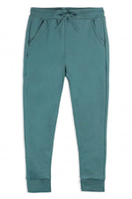A pair of teal green sweatpants with an elastic waistband, drawstring, side pockets, and ribbed ankle cuffs, shown flat on a white background. 