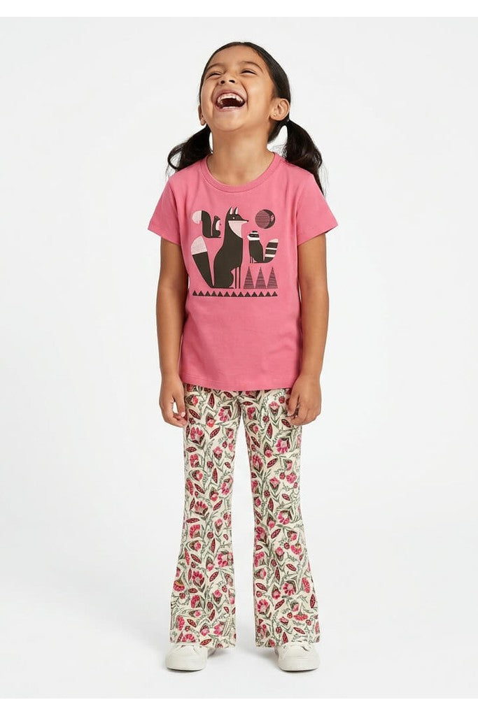 Young girl wearing a Mightly 100% organic cotton graphic tee with a graphic fox print and floral print pants. 