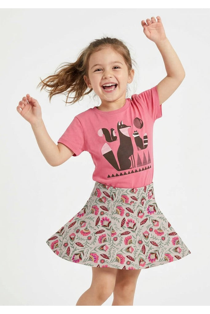 Young girl wearing a Mightly 100% organic cotton graphic tee with a graphic fox print and a floral skirt. 