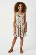 Young girl wearing a floral dress on a white background