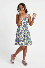 Girl wearing a purple floral dress on a white background