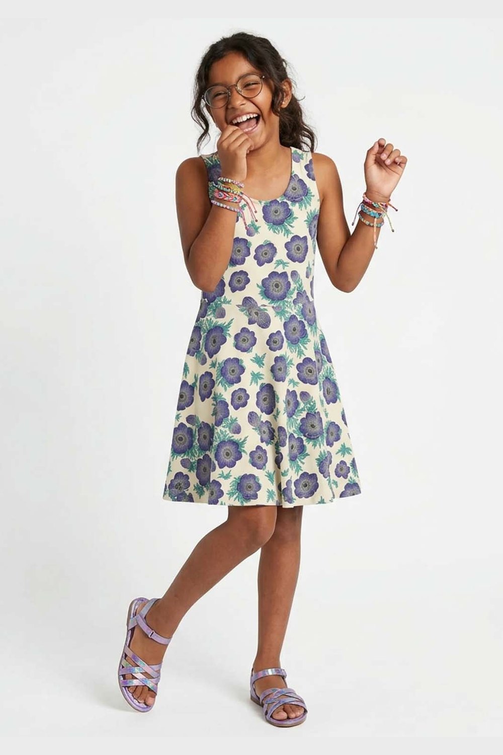 Girl wearing a purple floral dress on a white background