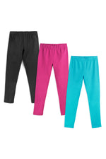 Three pairs of kids' organic cotton leggings in a 3-pack, one is black, one is pink and one is turquoise, stacked on a white background