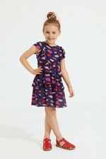 Young girl wearing a colorful dress with a white background