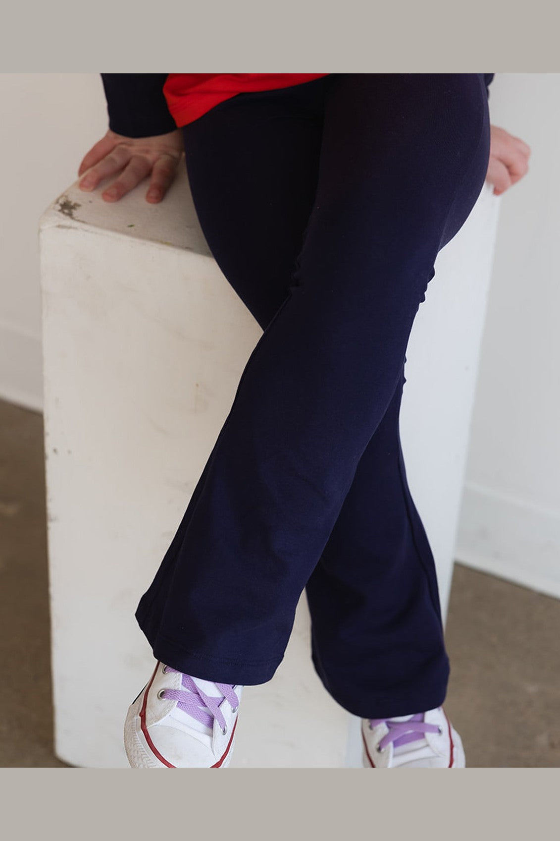 close up of a child wearing navy blue yoga pants