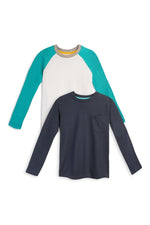 Two long-sleeve kids' shirts, one navy blue with a pocket and one white with teal sleeves, laid flat.